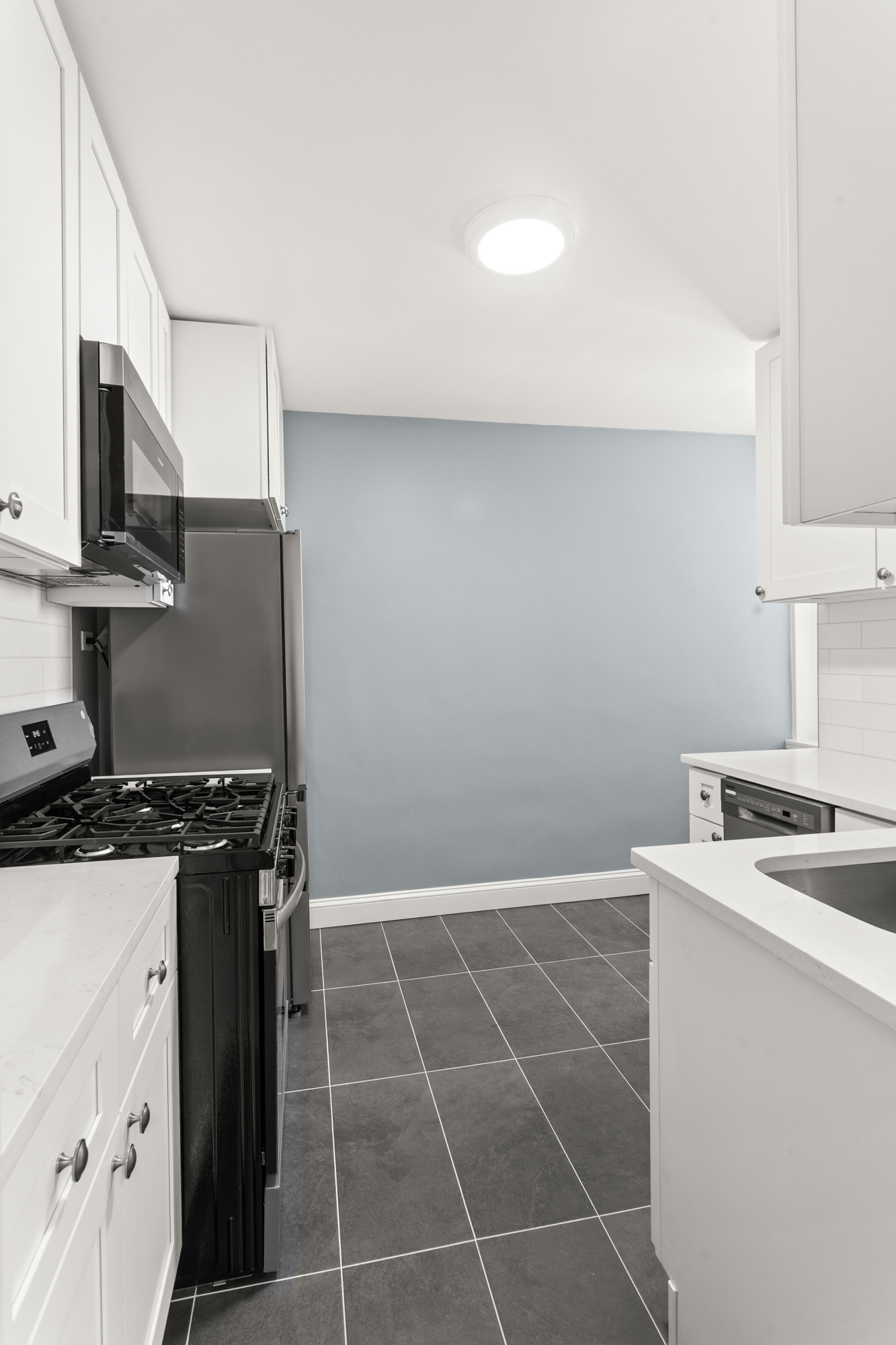 5650 Netherland Avenue, Unit 6C Bronx, NY 10471 - Photo 4 of 16 a kitchen with a stove a sink and a microwave