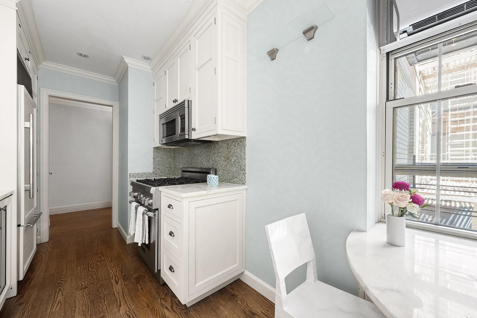 75 Bank Street, Unit 2H Manhattan, NY 10014 - Photo 8 of 18 a kitchen with a stove a sink and a refrigerator