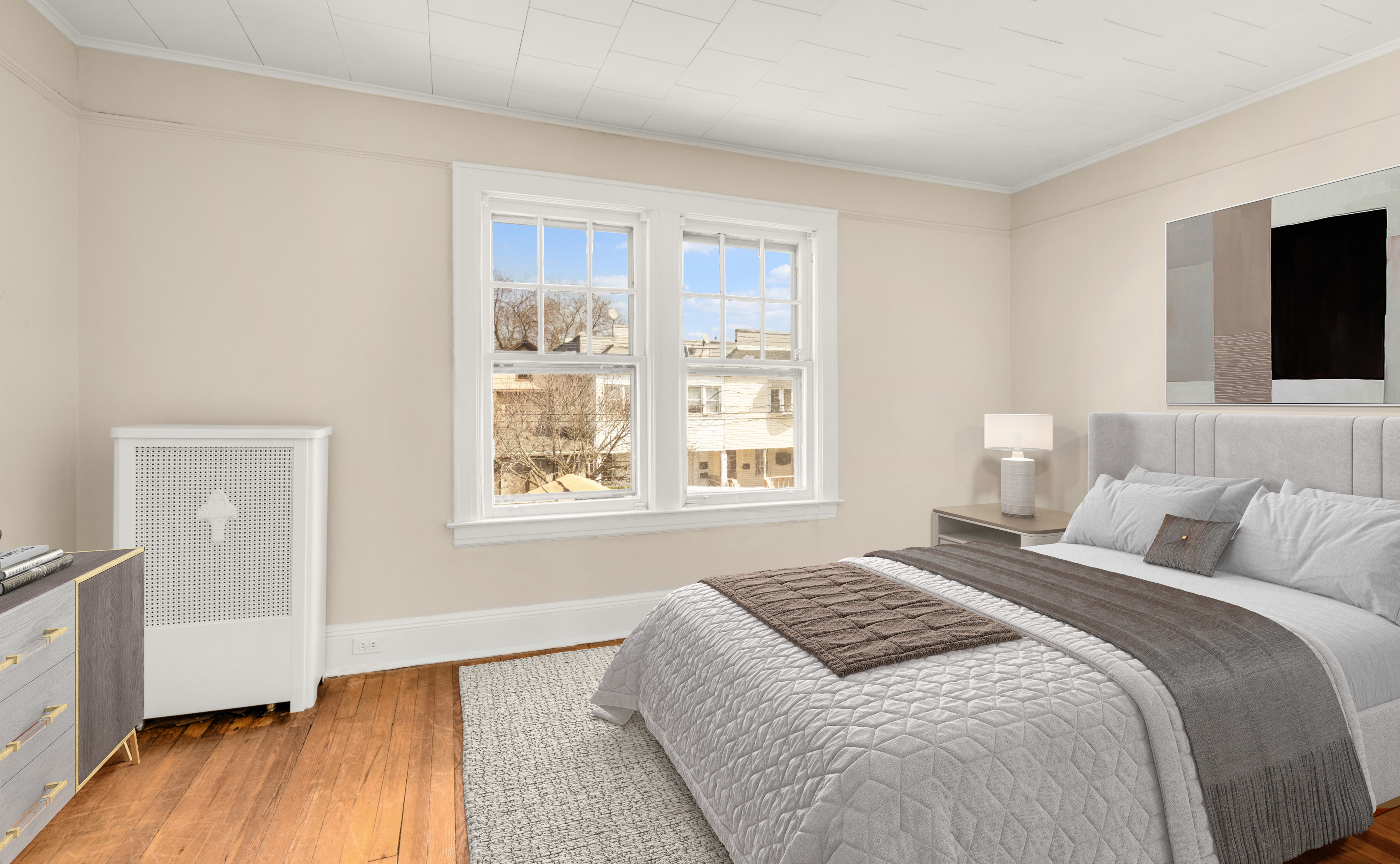 107-28 118th Street Queens, NY 11419 - Photo 7 of 12 a bedroom with a large bed and a window