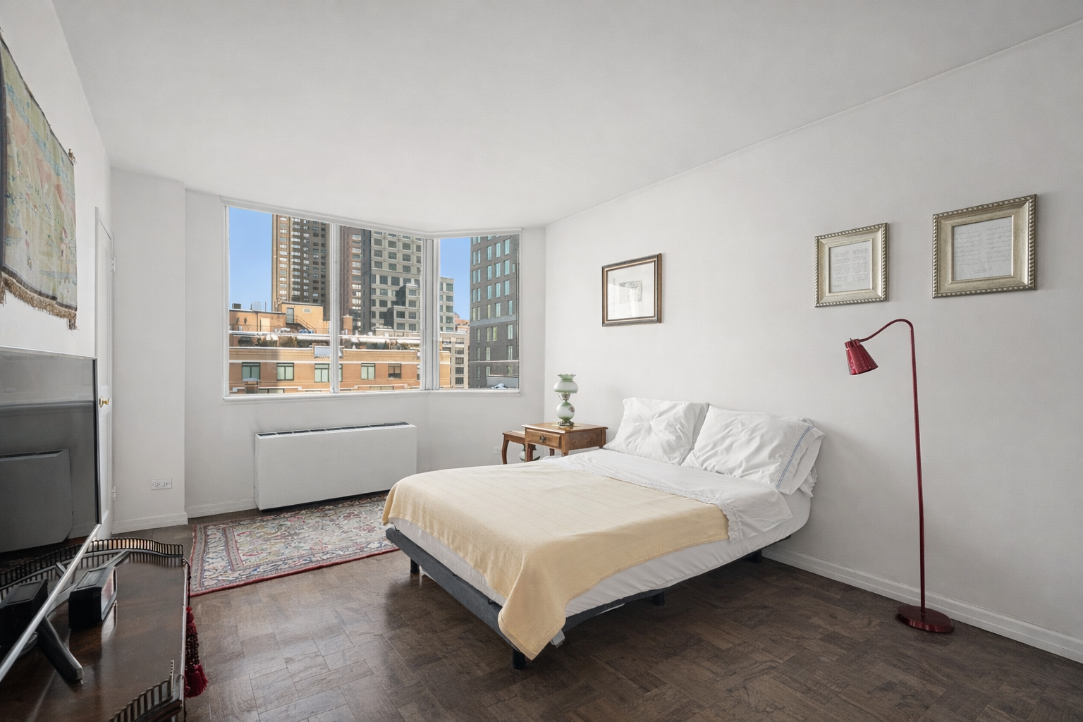 515 East 79th Street, Unit 15A Manhattan, NY 10075 - Photo 8 of 26 a bed sitting in a bedroom next to a window