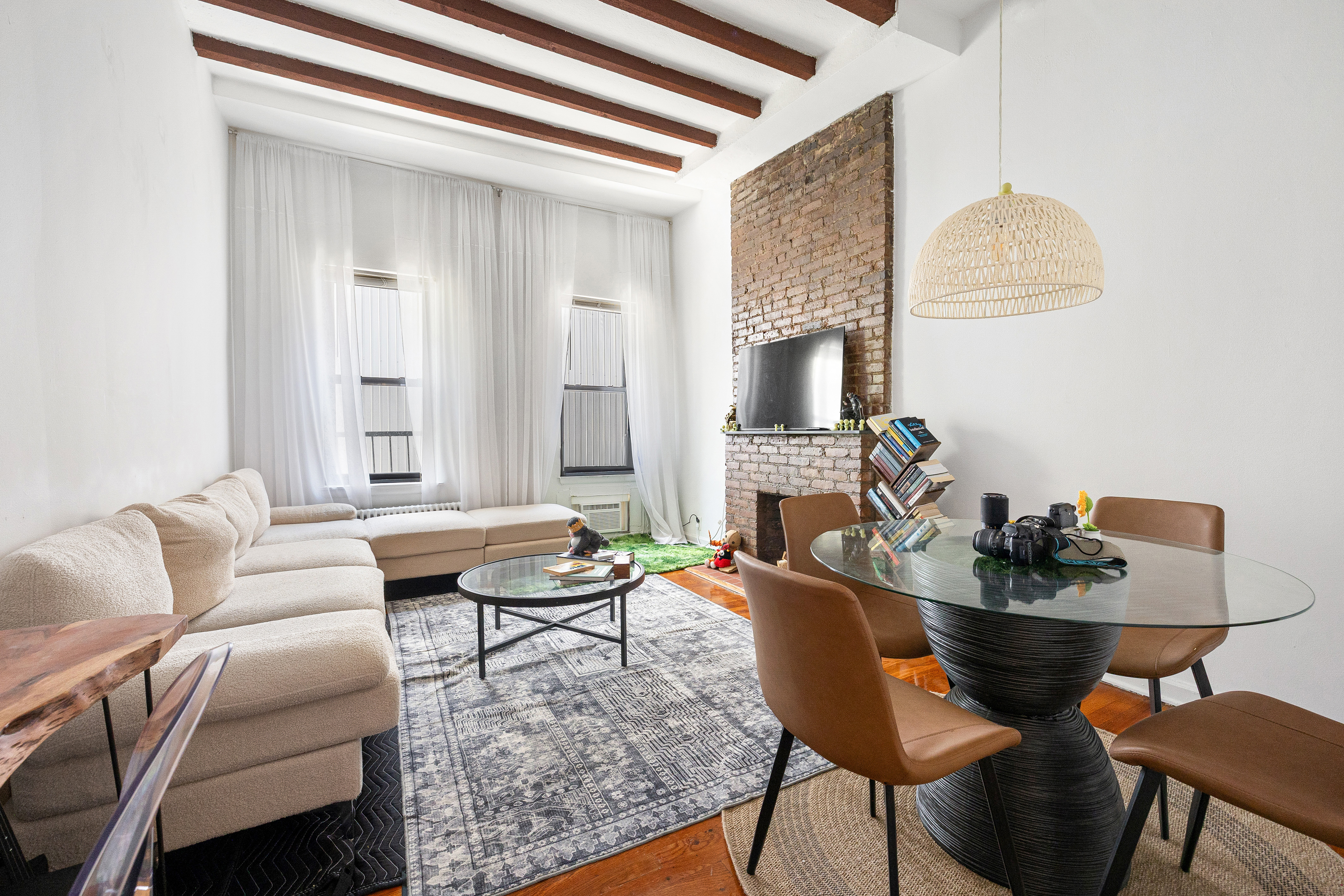 a living room with furniture and a potted plant