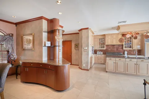 a view of a kitchen with refrigerator and cabinets