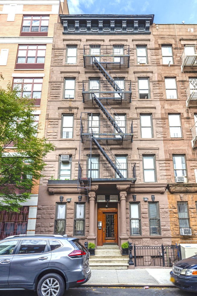 245 West 115th Street, Unit 16 Manhattan, NY 10026 - Photo 9 of 10 a car parked in front of a building