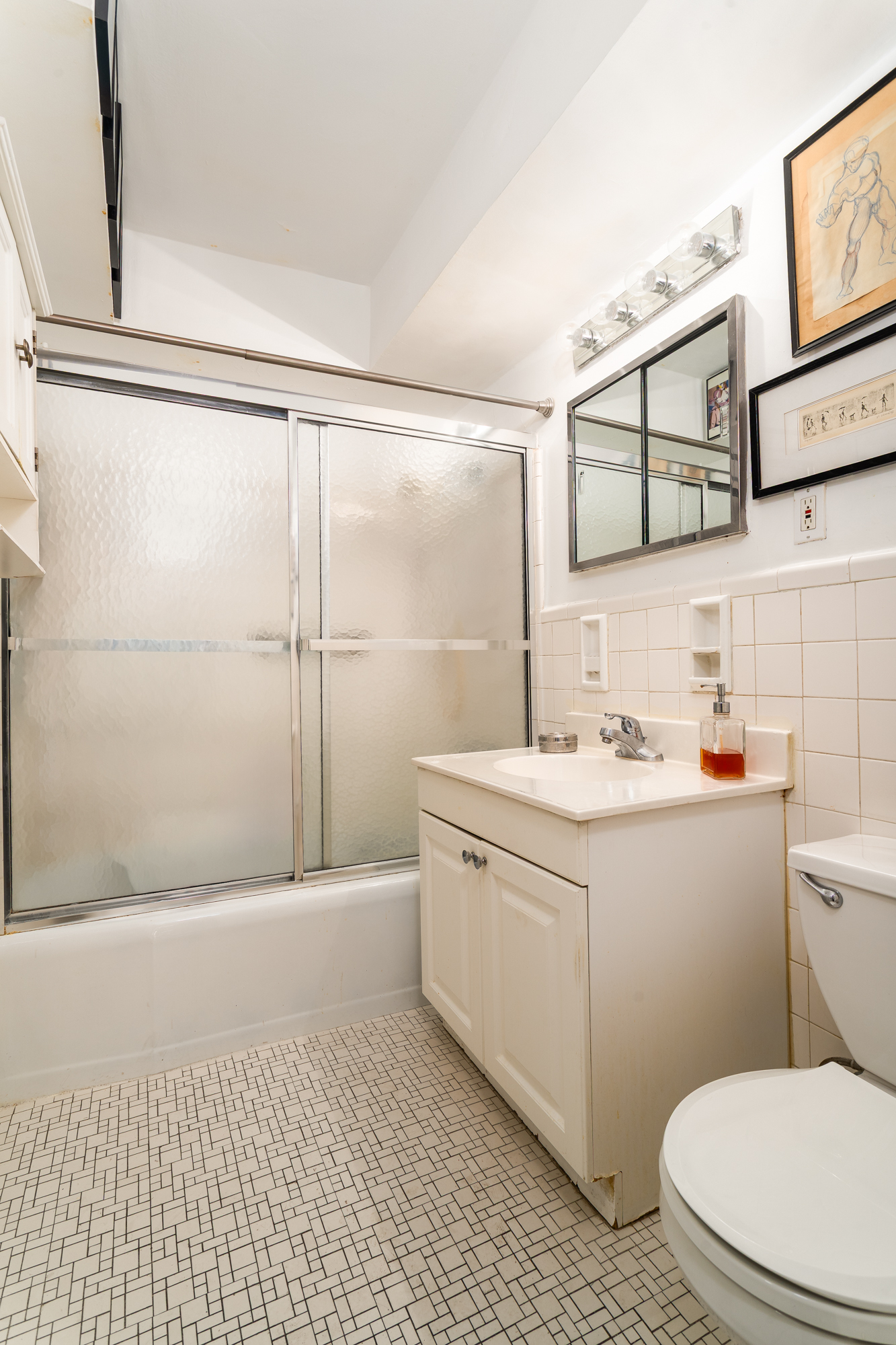 357 East 57th Street, Unit 5C Manhattan, NY 10022 - Photo 8 of 13 a bathroom with a sink a toilet and shower