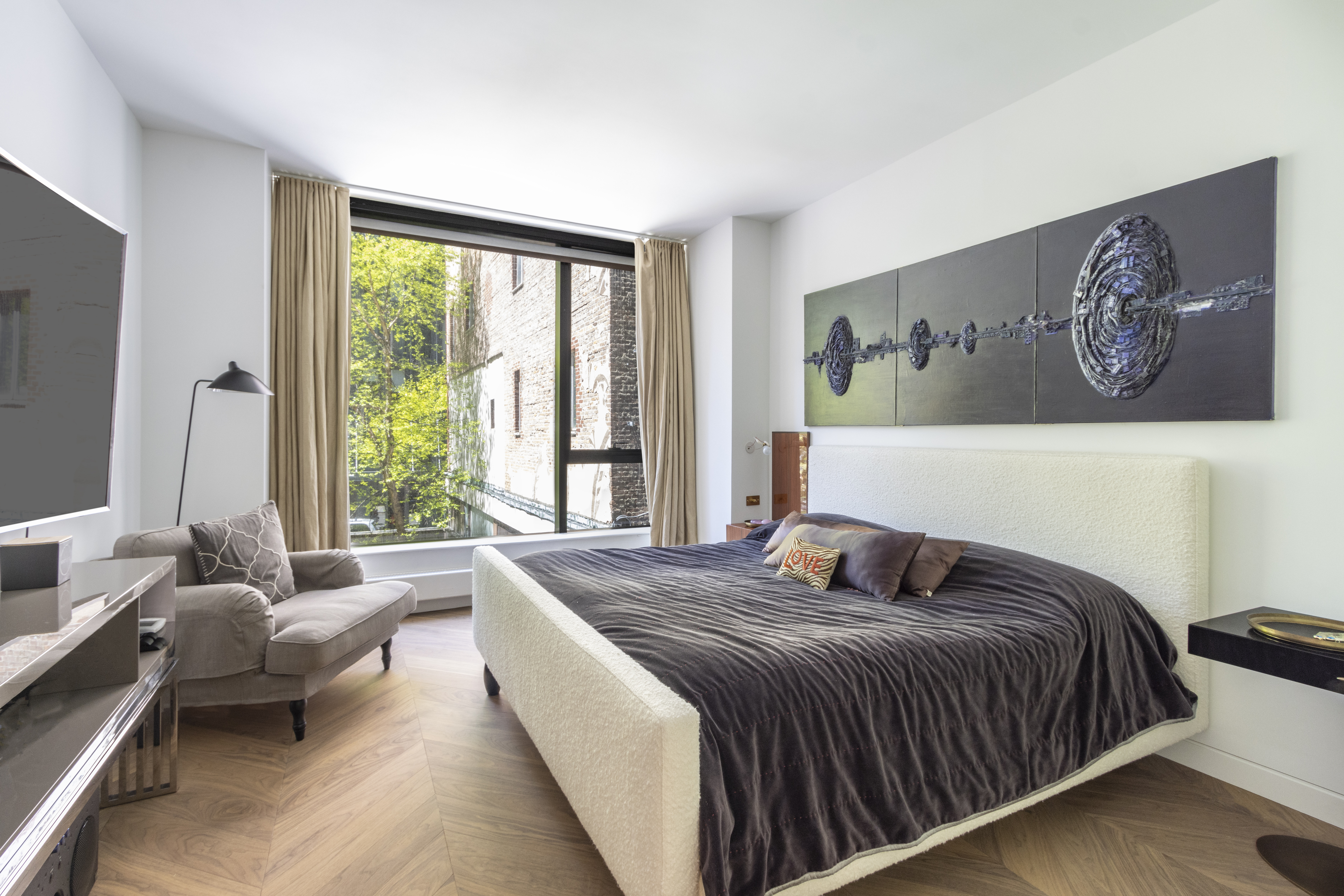 255 Hudson Street, Unit TH3 Manhattan, NY 10013 - Photo 7 of 11 a bedroom with a bed couch and a large window