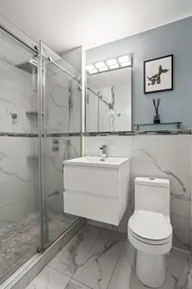 a bathroom with a toilet sink and shower