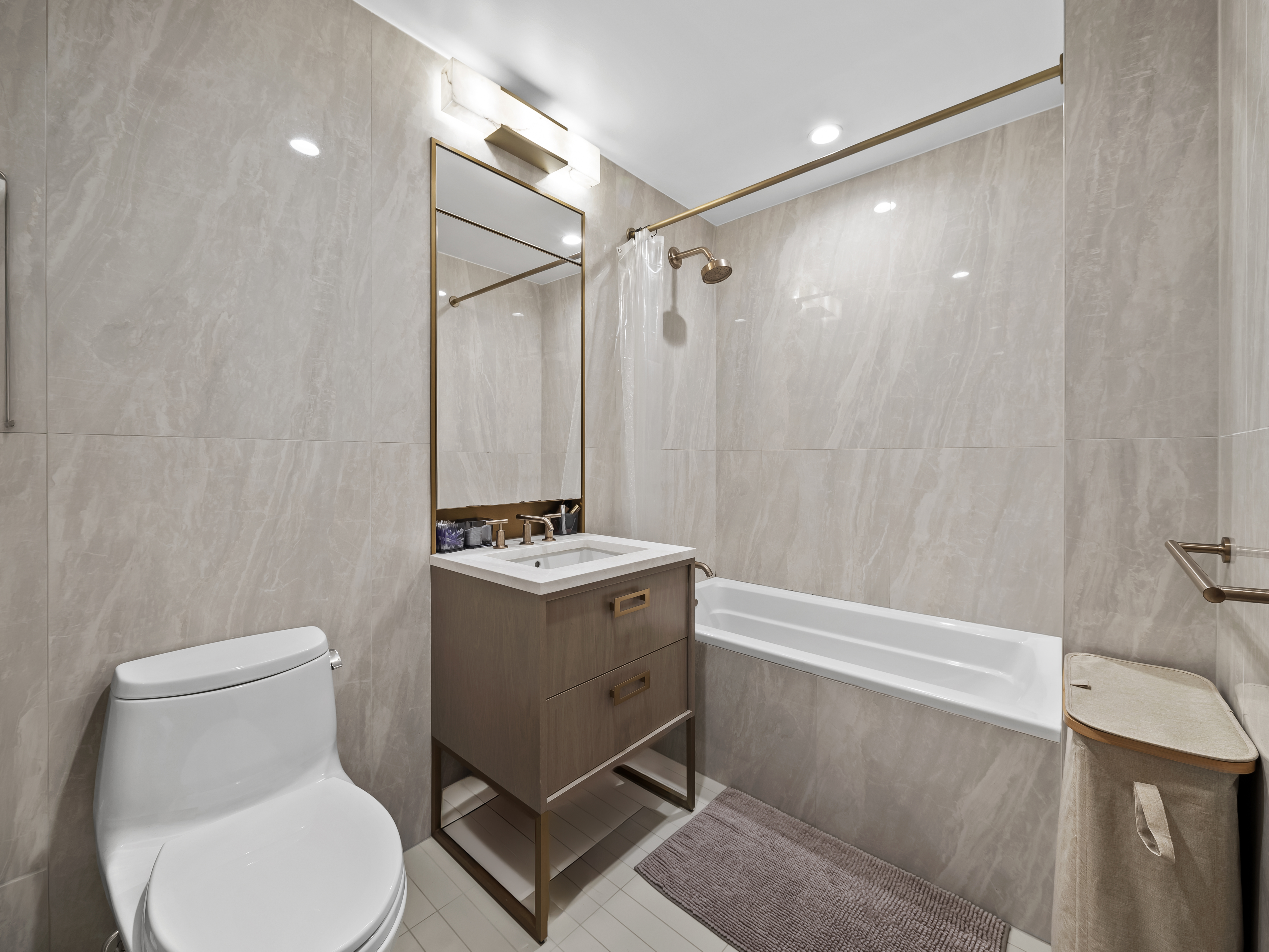45-3 Court Square, Unit 4406 Queens, NY 11101 - Photo 9 of 22 a bathroom with a toilet sink and shower