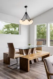 a view of a dining room with furniture wooden floor and chandelier