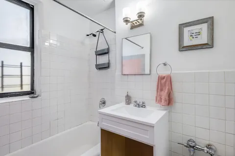 a bathroom with a sink a vanity and shower