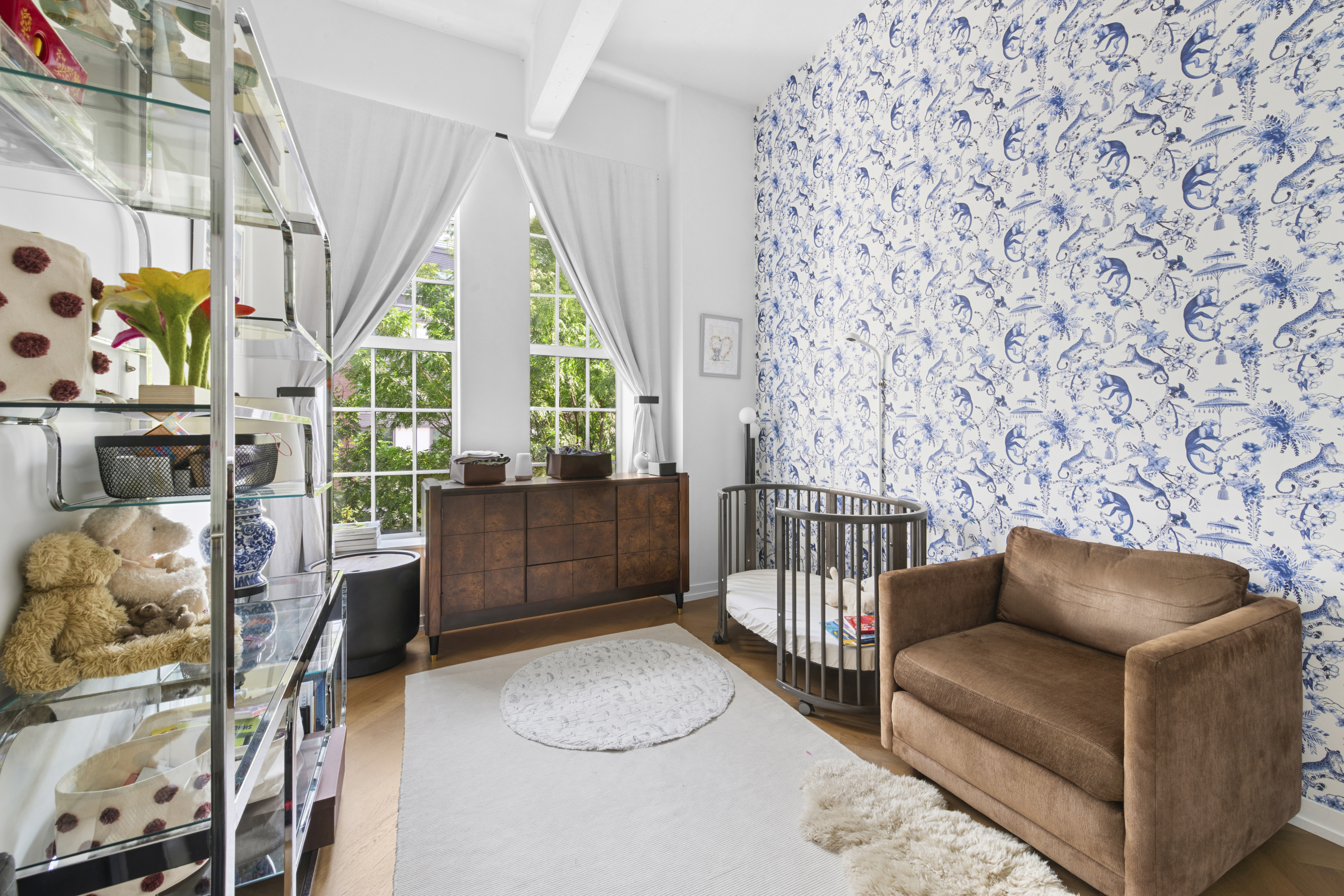 184 Kent Avenue, Unit D315 Brooklyn, NY 11249 - Photo 7 of 19 a living room with furniture a flat screen tv and a floor to ceiling window