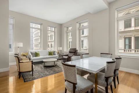 a view of a dining room with furniture window and wooden floor