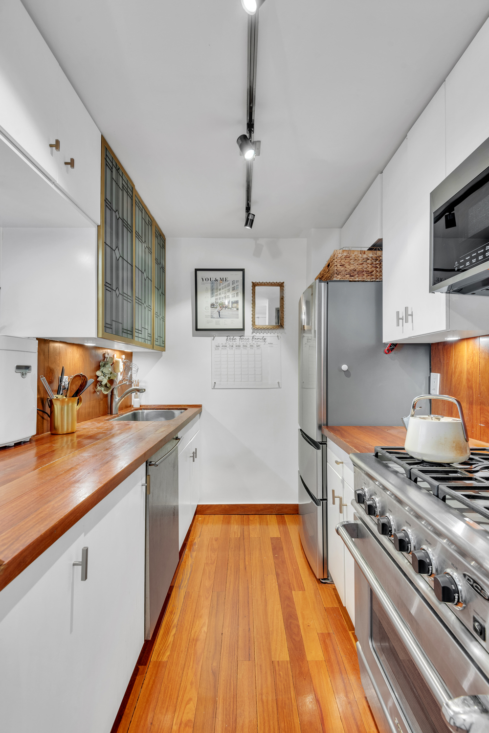 225 East 57th Street, Unit 14A Manhattan, NY 10022 - Photo 4 of 8 a kitchen with stainless steel appliances a stove a sink and a refrigerator