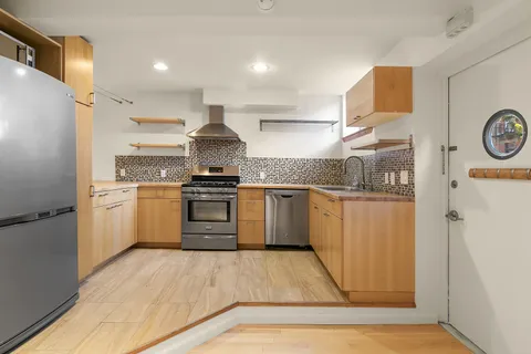 a kitchen with a white cabinets and white appliances