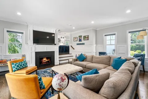a living room with furniture fireplace and window