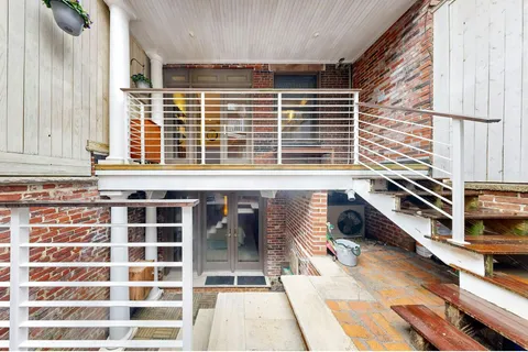 a balcony with table and chairs