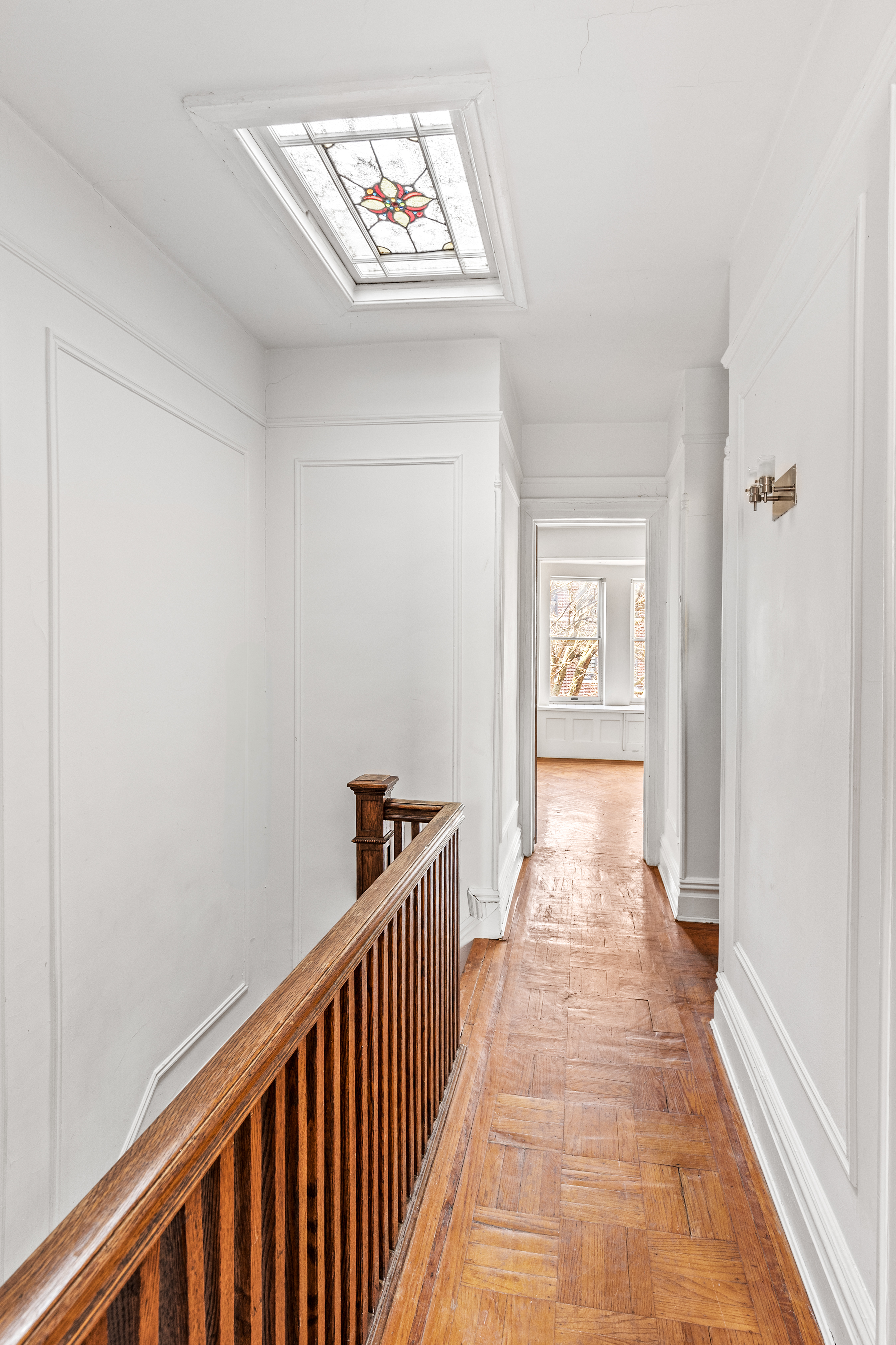 555 16th Street Brooklyn, NY 11215 - Photo 10 of 19 a view of a hallway with wooden floor and a bathroom