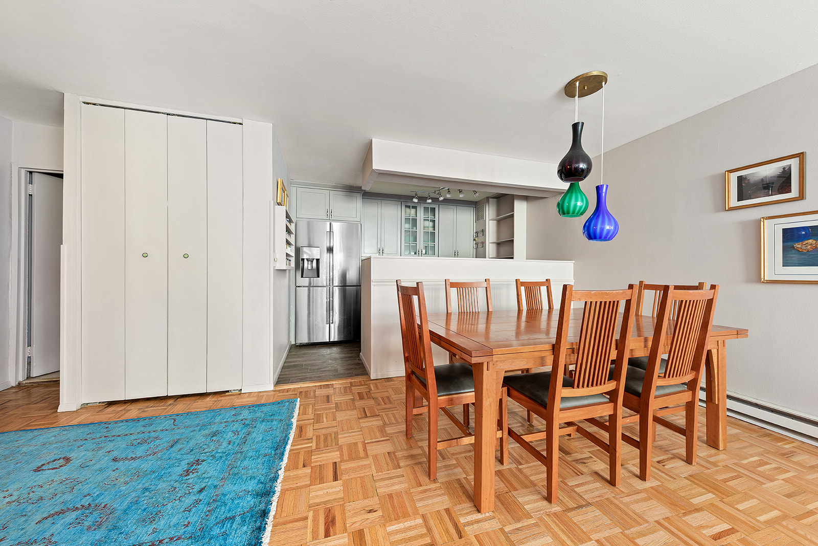 a dining room with furniture and wooden floor