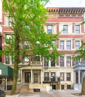 a front view of a building with a garden