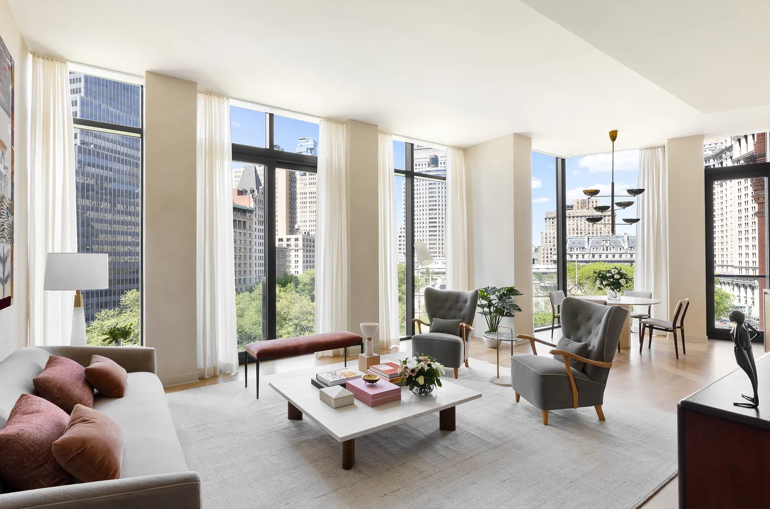 a living room with furniture and floor to ceiling windows