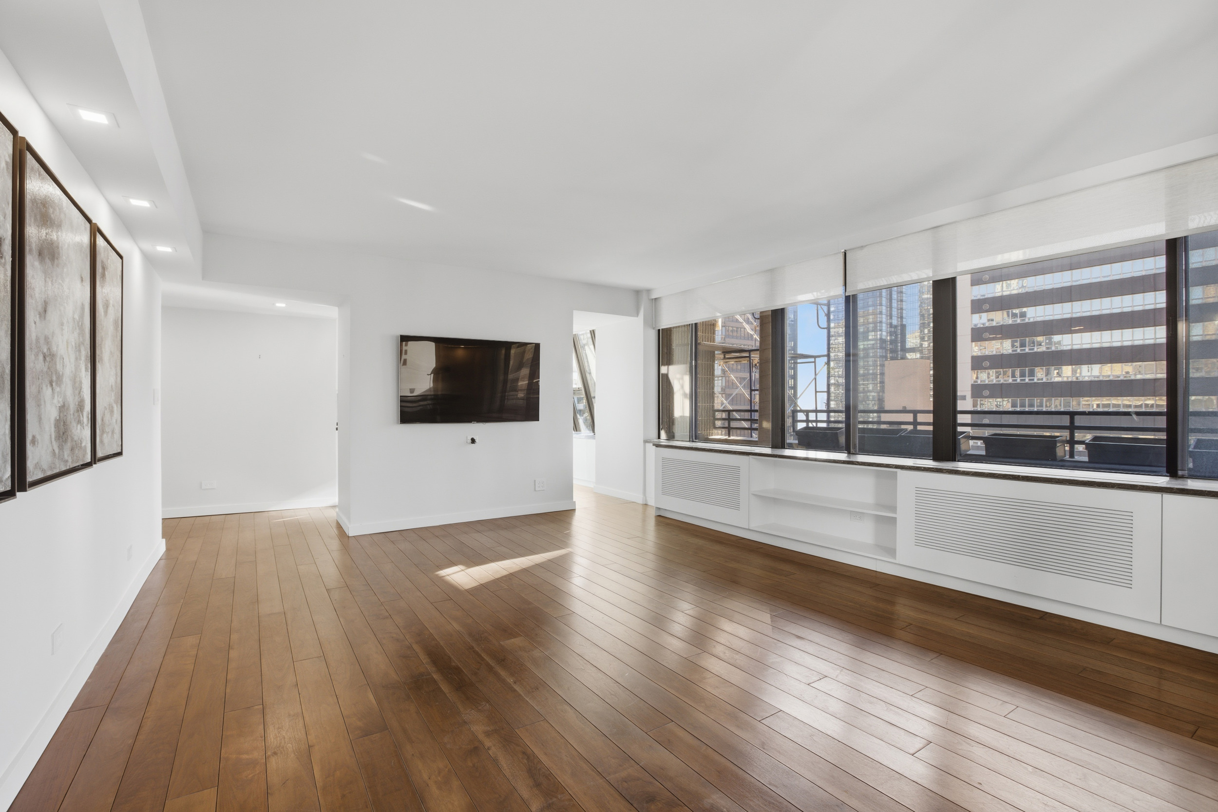 309 East 49th Street, Unit 21A Manhattan, NY 10017 - Photo 4 of 18 a view of an empty room with wooden floor and a window
