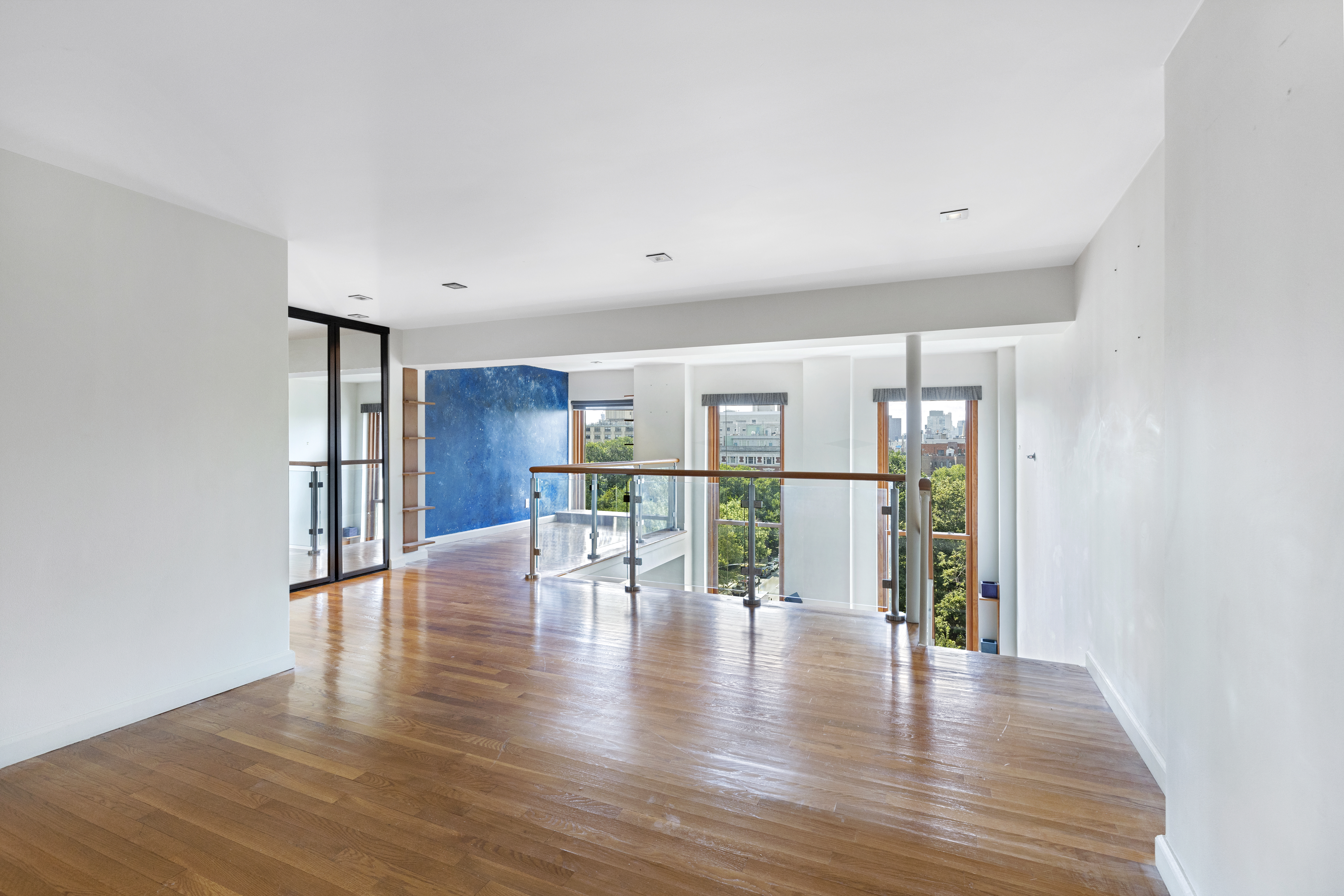 305 2nd Avenue, Unit 537 Manhattan, NY 10003 - Photo 7 of 11 a view of an empty room with wooden floor and a window