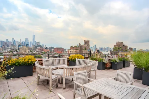 a view of a roof deck with furniture