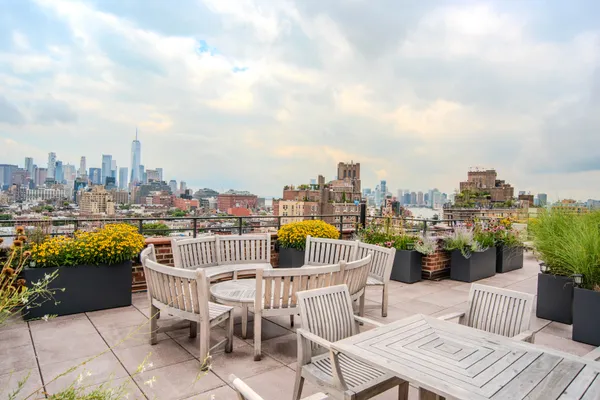 a view of a roof deck with furniture