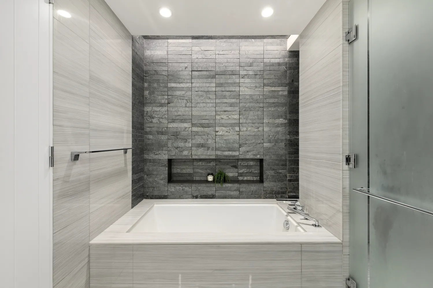a bathroom with a bathtub and shower