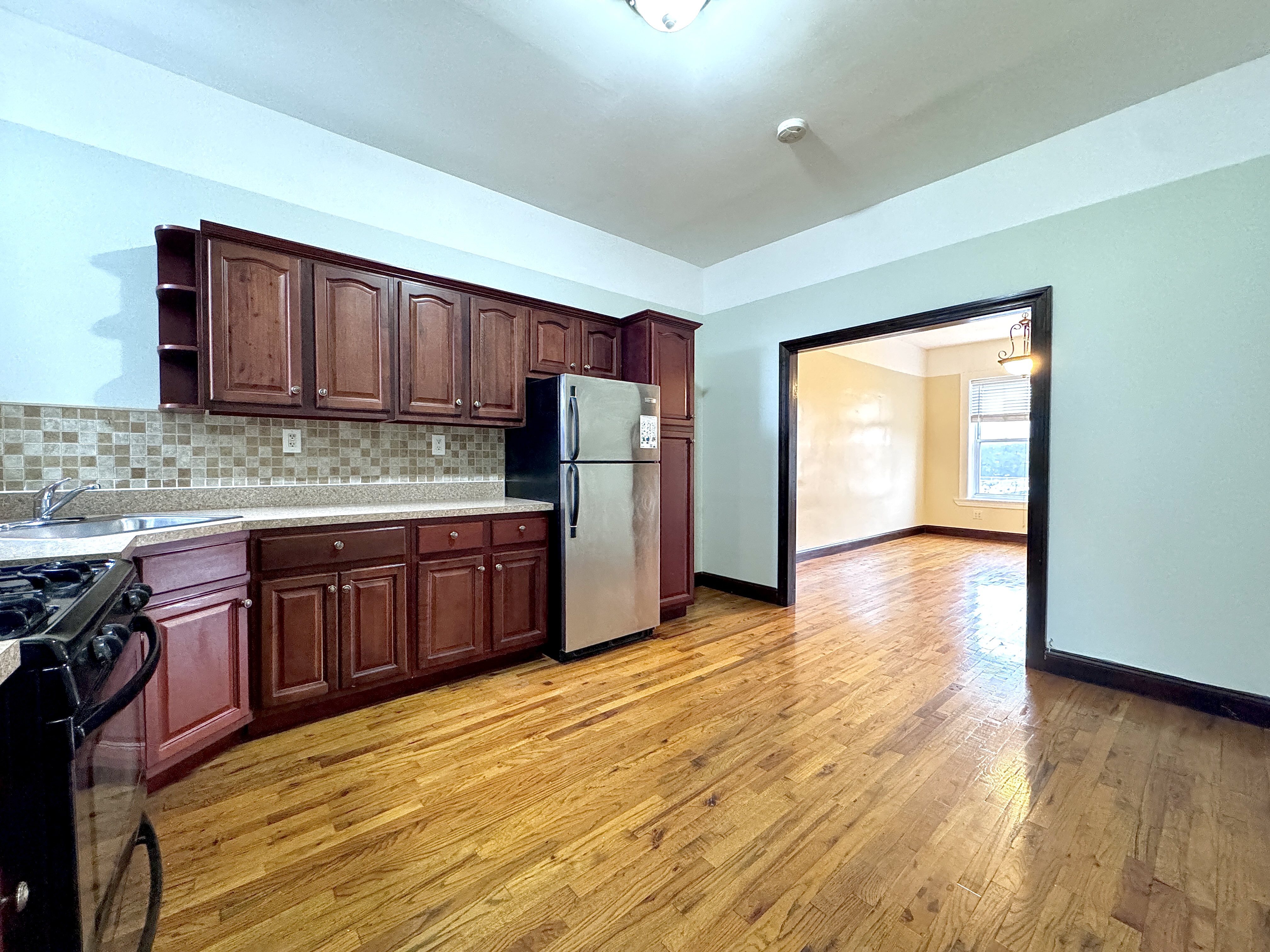 497 Park Place, Unit 4 Brooklyn, NY 11238 - Photo 8 of 14 a kitchen with stainless steel appliances granite countertop a stove a sink and a refrigerator