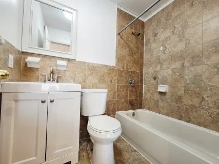 a bathroom with a toilet sink and shower