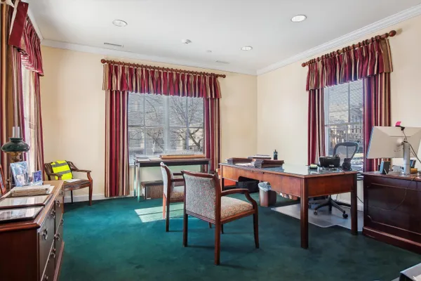 a dining room with furniture window and wooden floor