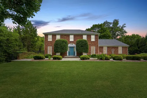 a view of a brick house with a yard