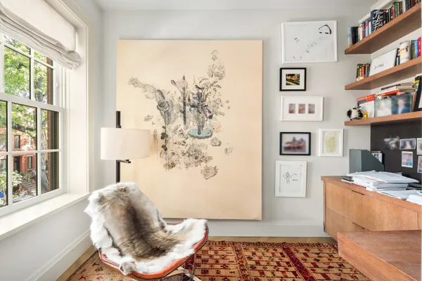 a view of a garden with a bench and trees