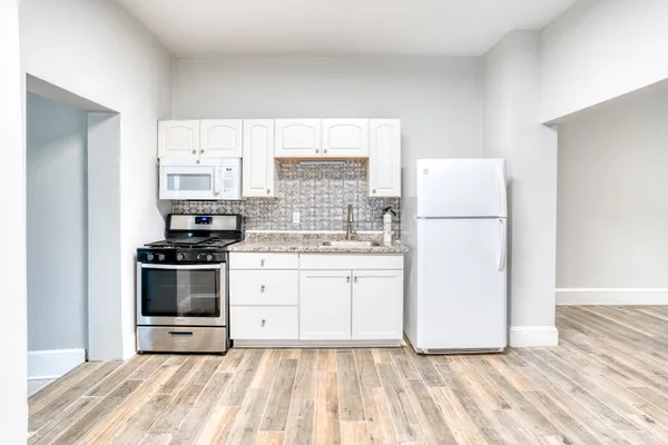 a kitchen with a white cabinets and white appliances
