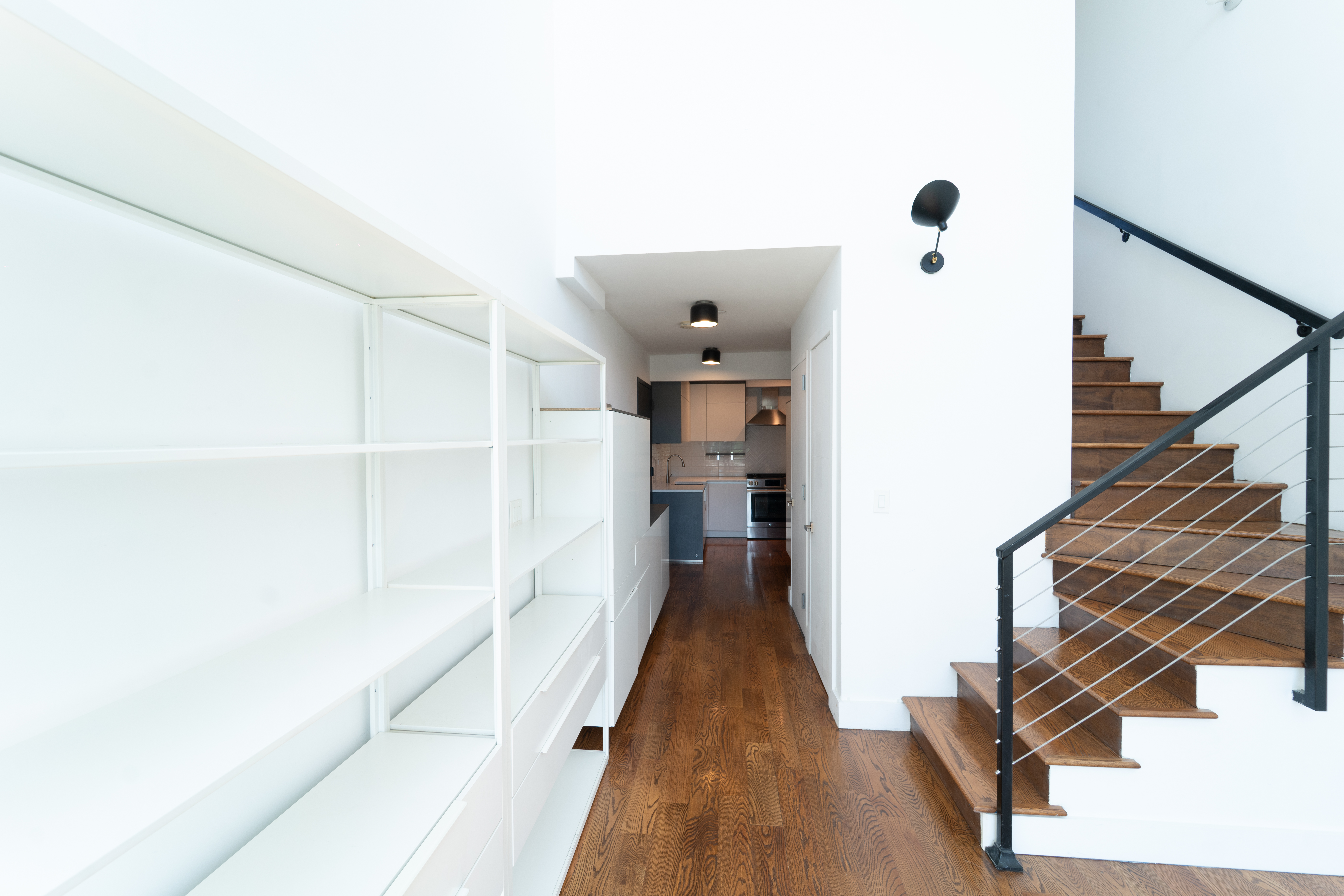 299 Van Buren Street, Unit 4C Brooklyn, NY 11221 - Photo 8 of 16 a view of a hallway with wooden floor and staircase