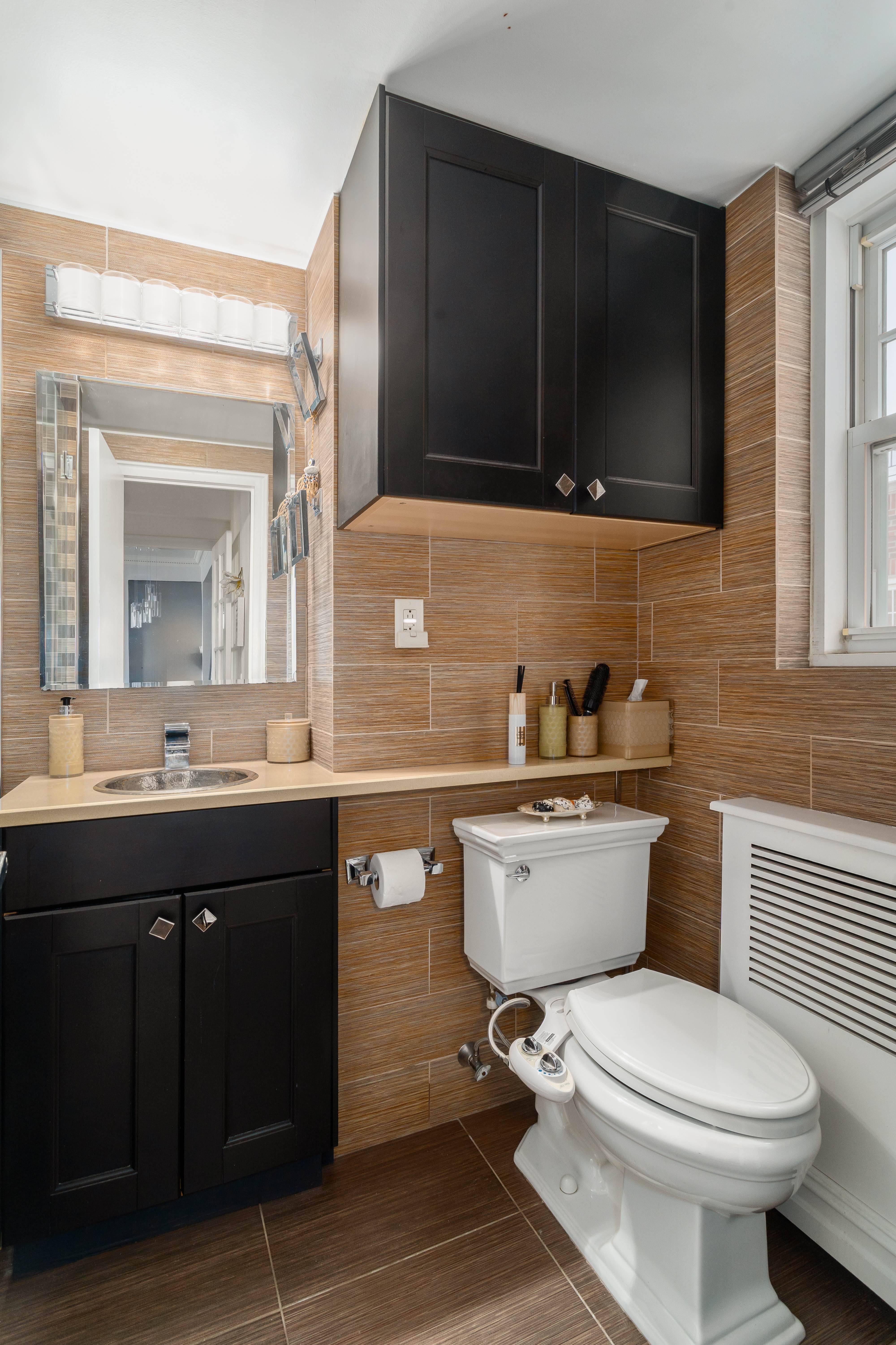 140 Cabrini Boulevard, Unit PH138 Manhattan, NY 10033 - Photo 12 of 30 a bathroom with a sink toilet a mirror and bathtub