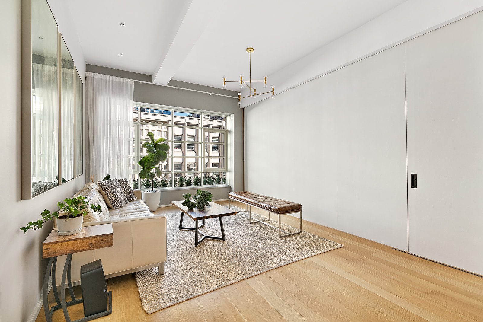 318 West 52nd Street, Unit 3N Manhattan, NY 10019 - Photo 2 of 9 a living room with furniture and a large window