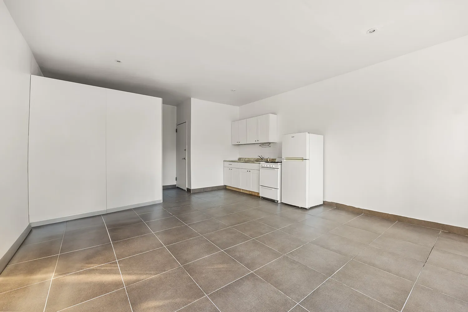 a view of kitchen with white cabinets and white appliances