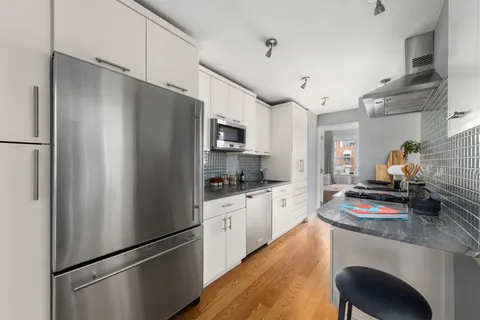 a kitchen with stainless steel appliances a refrigerator stove and sink