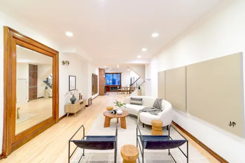 a dining room with furniture and wooden floor
