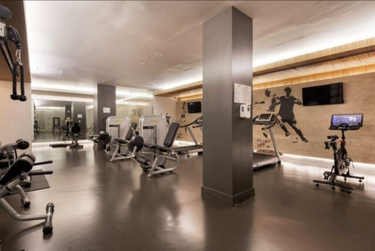 93 Worth Street, Unit 1006 Manhattan, NY 10013 - Photo 15 of 18 a view of a room with gym equipment
