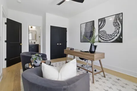 a living room with furniture and a wooden floor