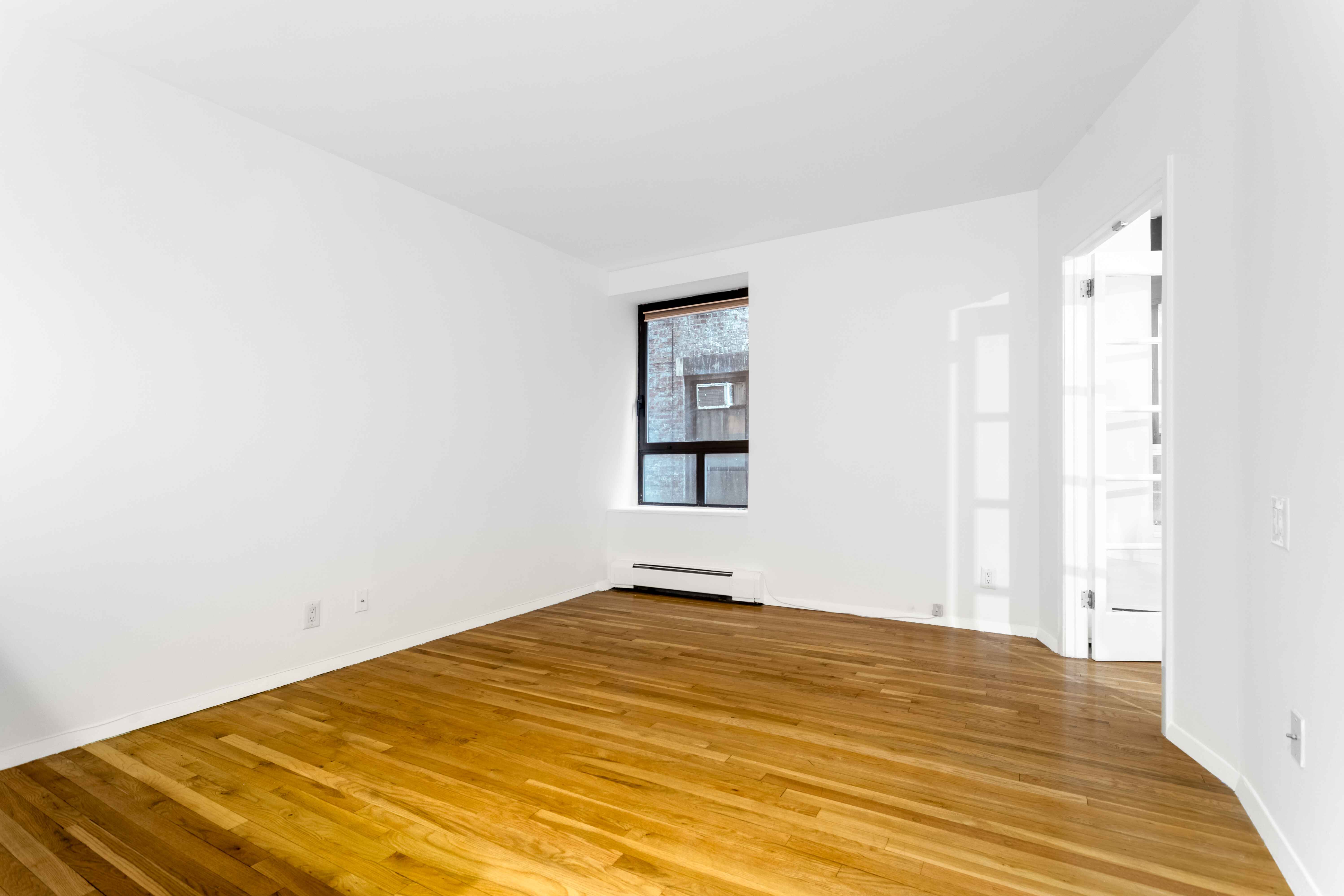250 West 88th Street, Unit 408 Manhattan, NY 10024 - Photo 6 of 10 a view of empty room with wooden floor and fan