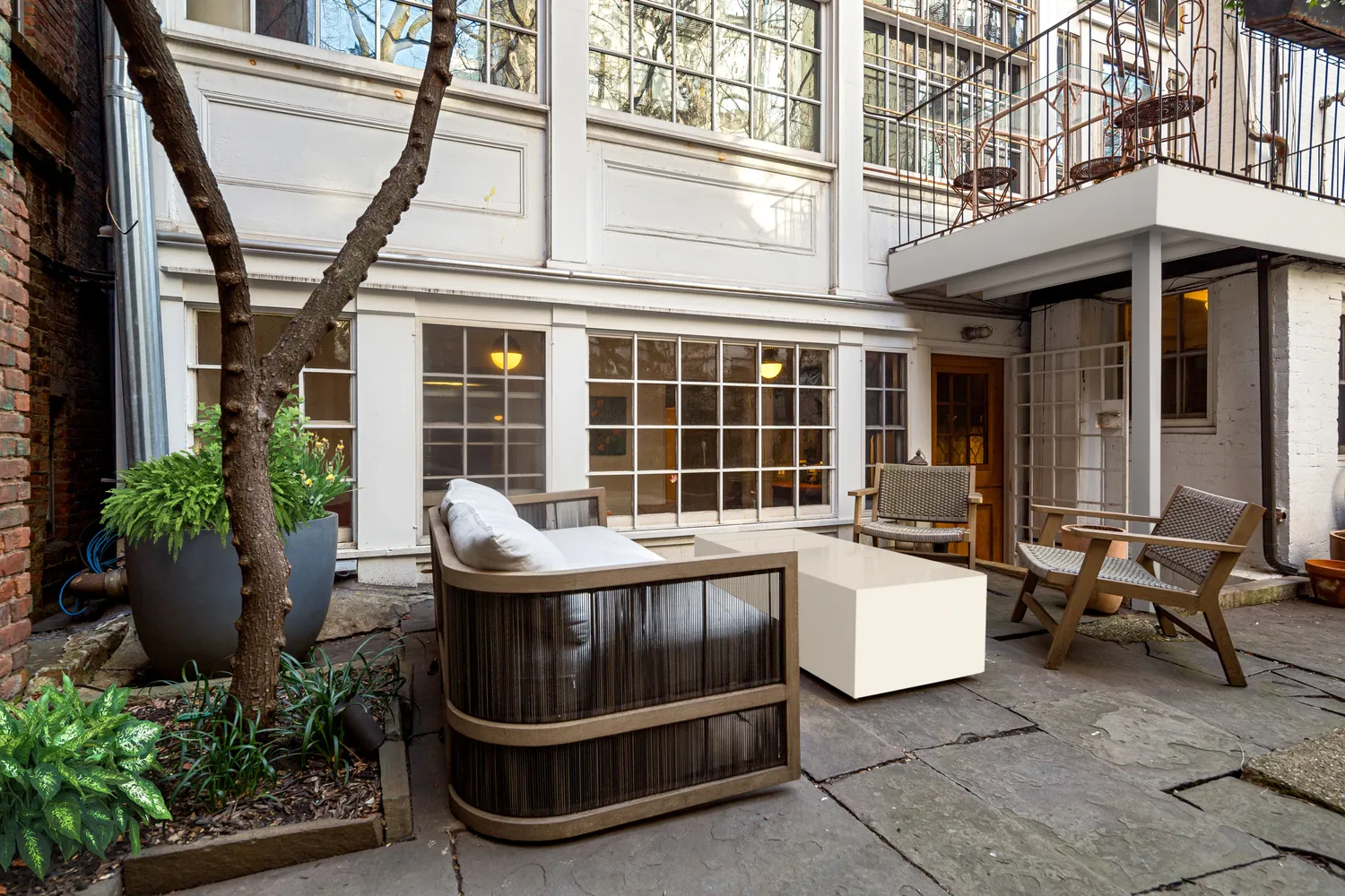 a view of a patio with a table and chairs and potted plants