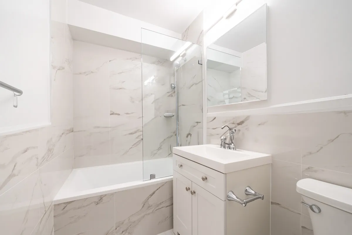 a bathroom with a sink mirror toilet and bathtub