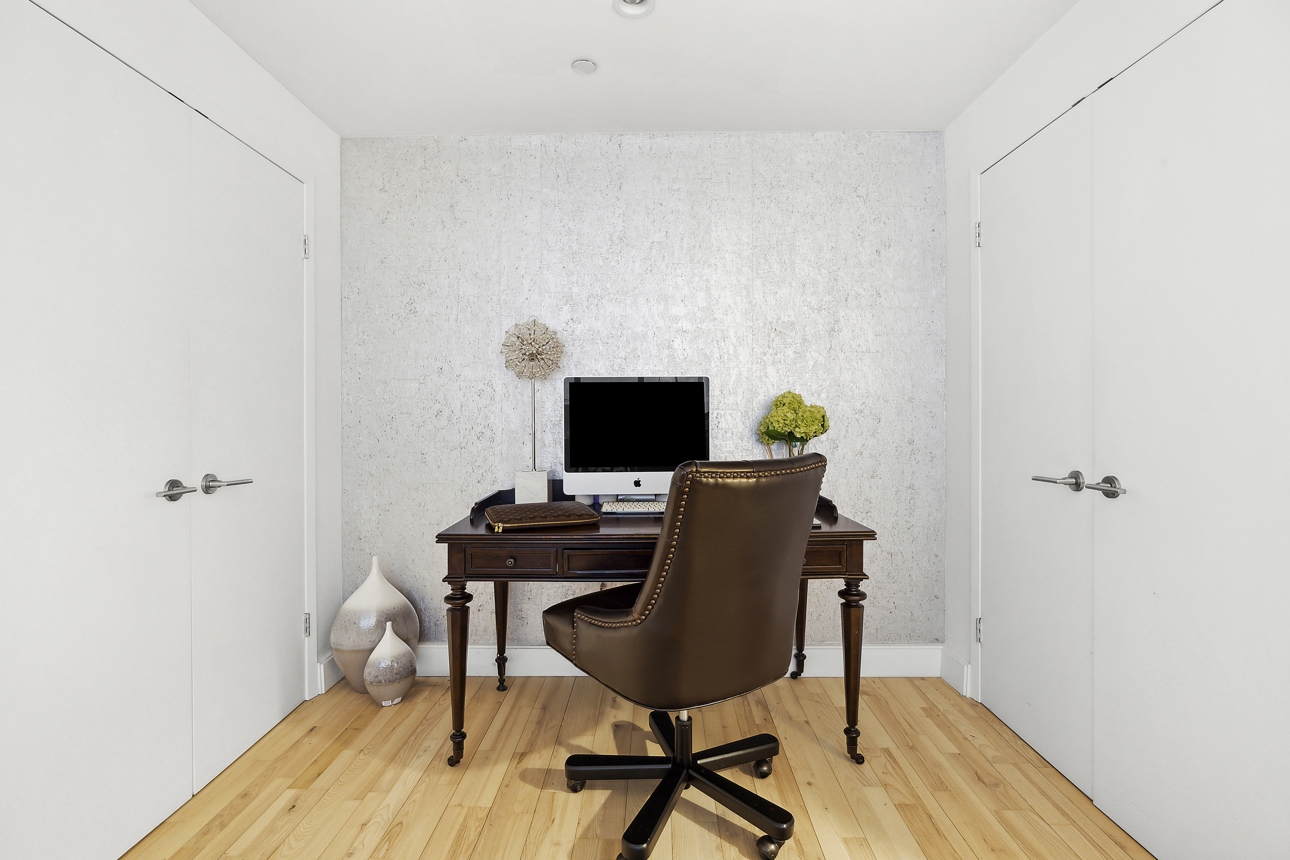 420 West 25th Street, Unit TH1E Manhattan, NY 10001 - Photo 11 of 22 a view of a workspace with furniture and wooden floor
