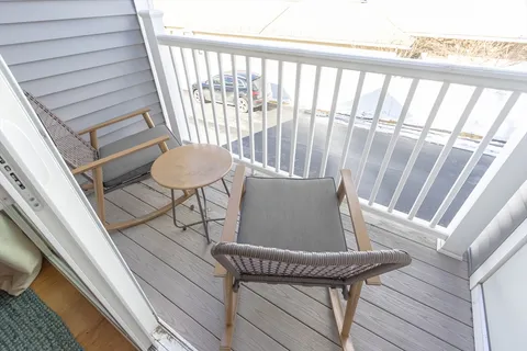 a view of a balcony with furniture
