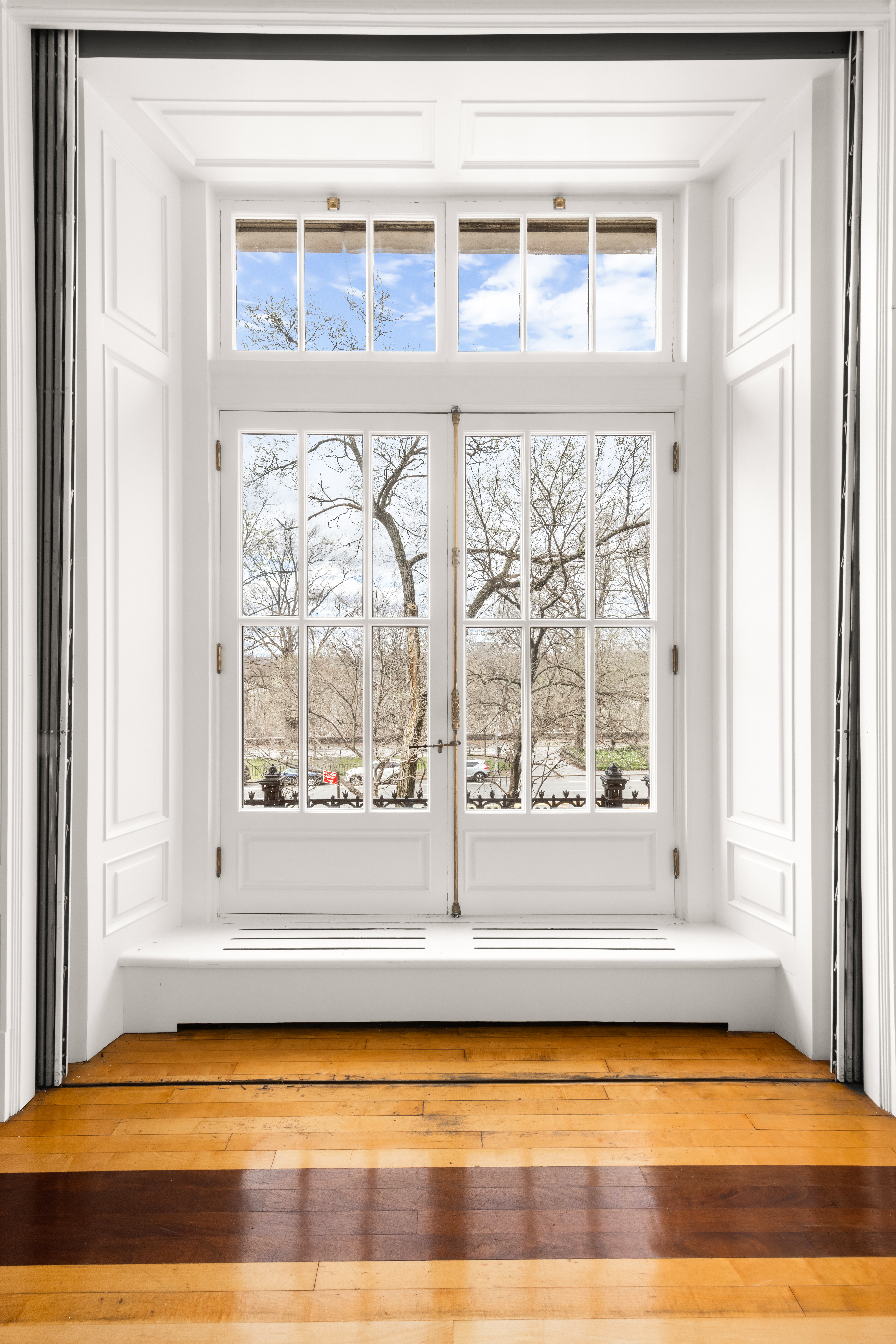 337 Riverside Drive Manhattan, NY 10025 - Photo 8 of 32 a view of an empty room with wooden floor and a window