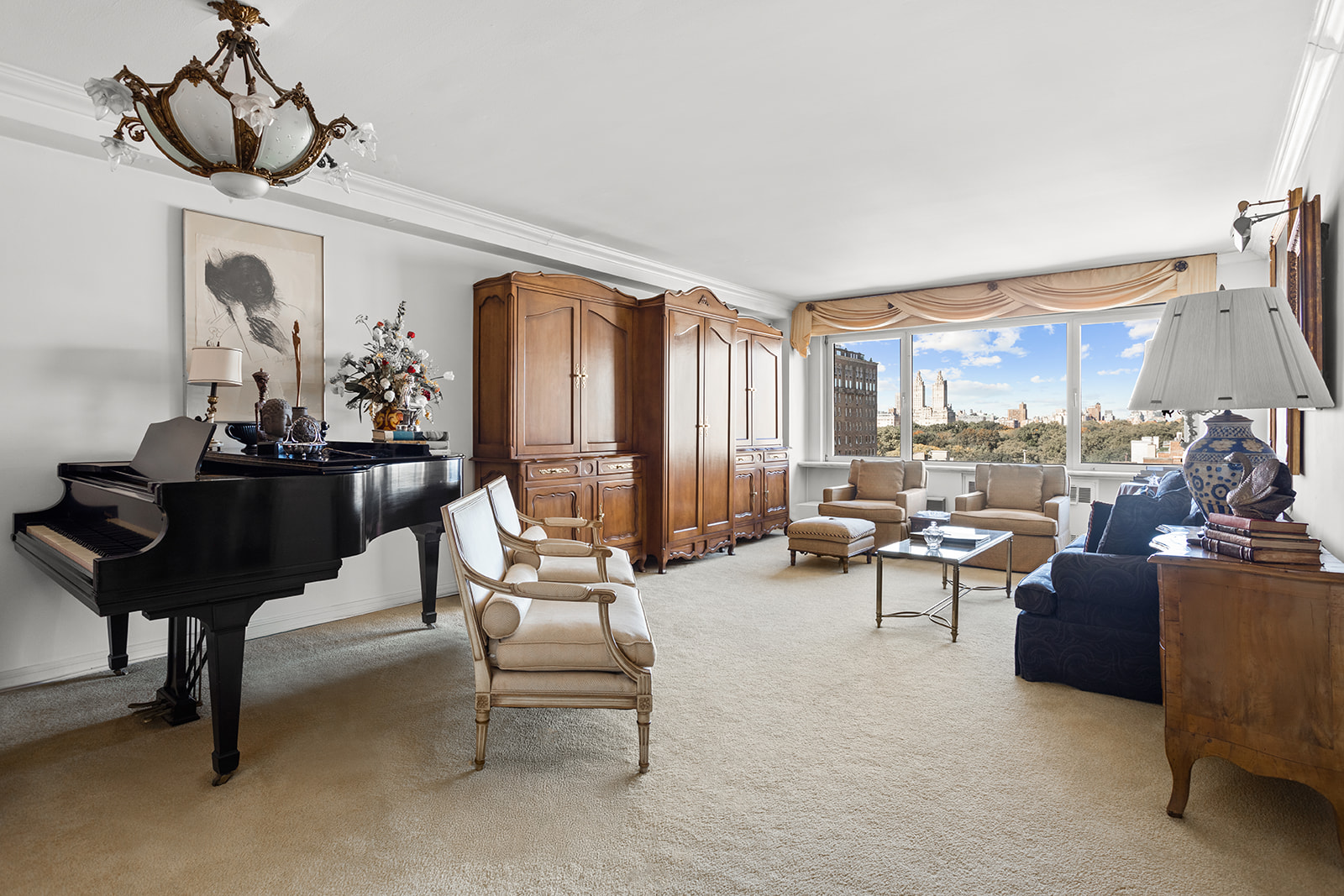 50 East 79th Street, Unit 12B Manhattan, NY 10075 - Photo 1 of 13 a living room with furniture and a chandelier