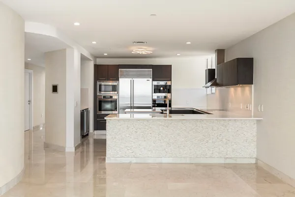 a view of a kitchen with a sink and cabinets